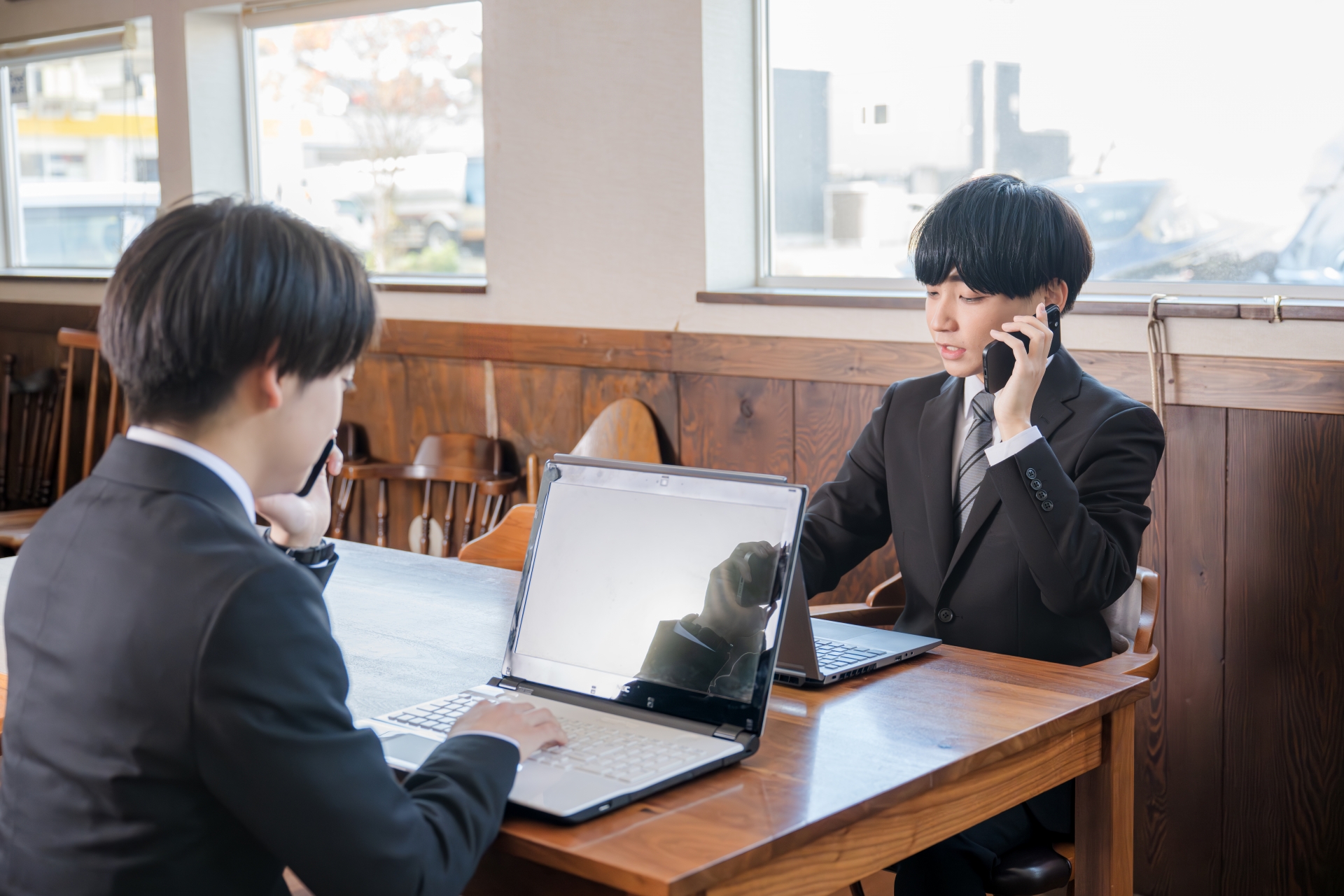 ノートPCに向かいテレアポ中のビジネスマン
